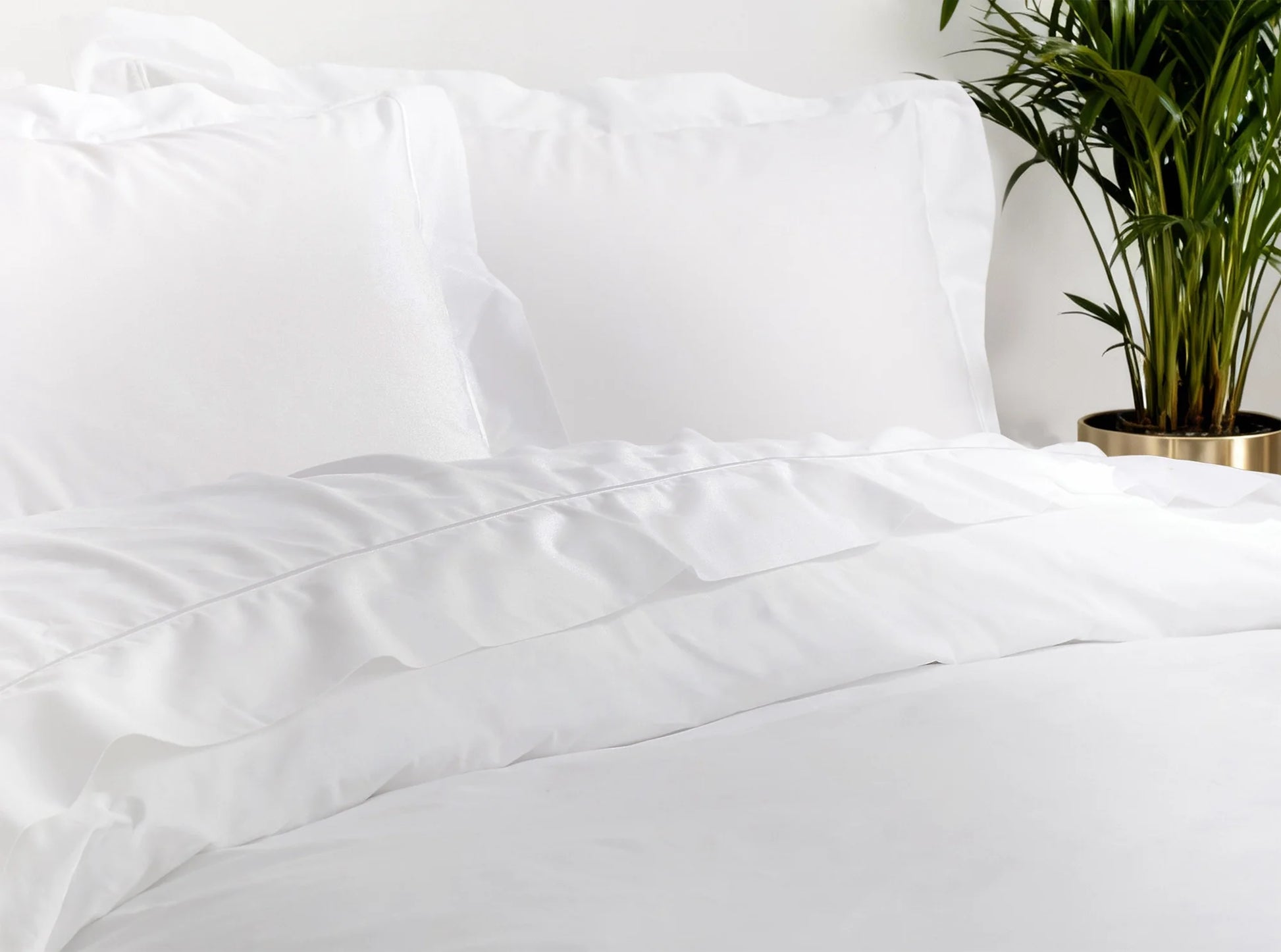 White organic percale bedding bundle styled on a bed in a modern bedroom with decorative accents-white-white