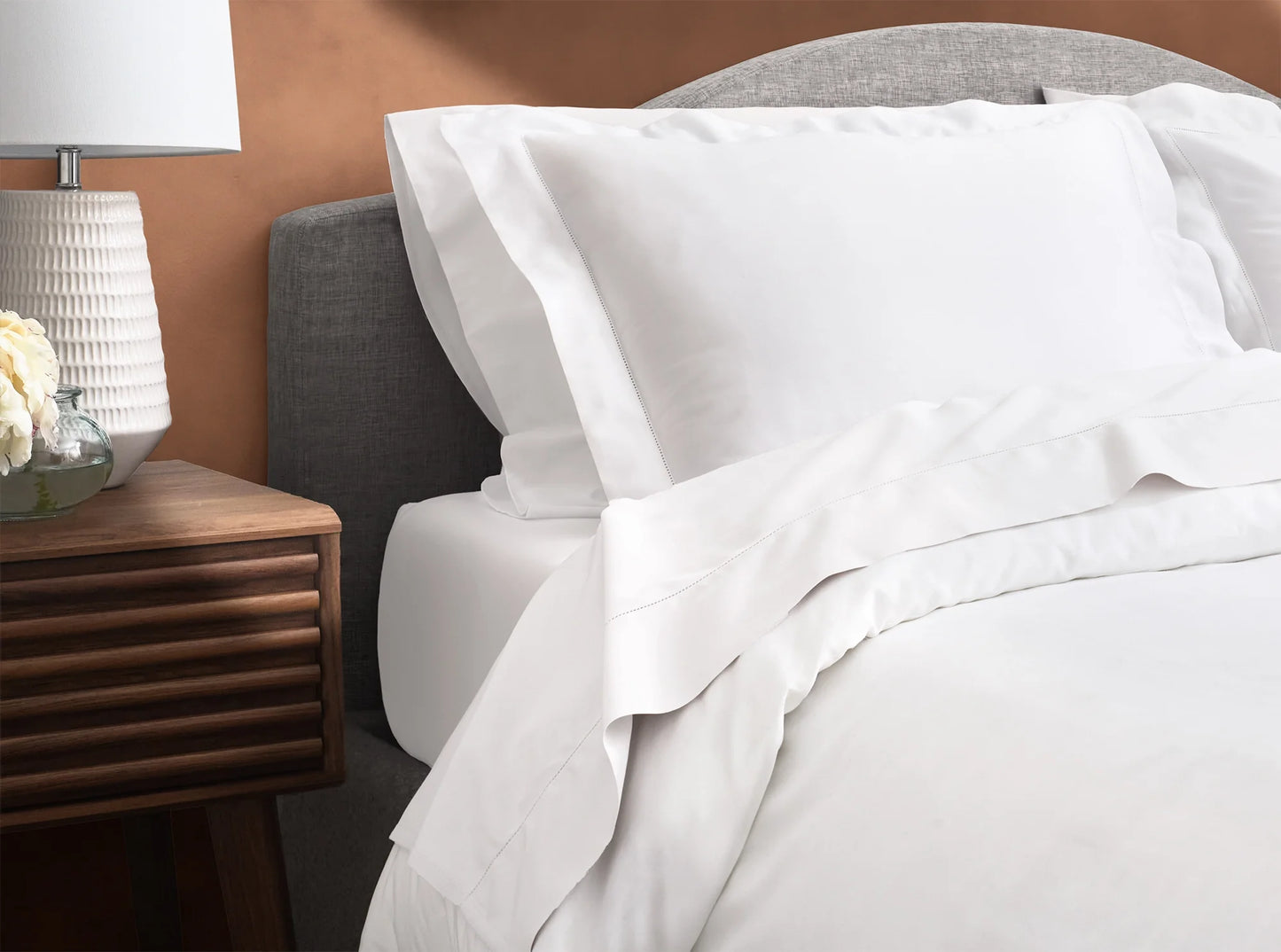 White organic cotton sateen bedding bundle on bed - sheets and duvet cover with hemstitched detail-white