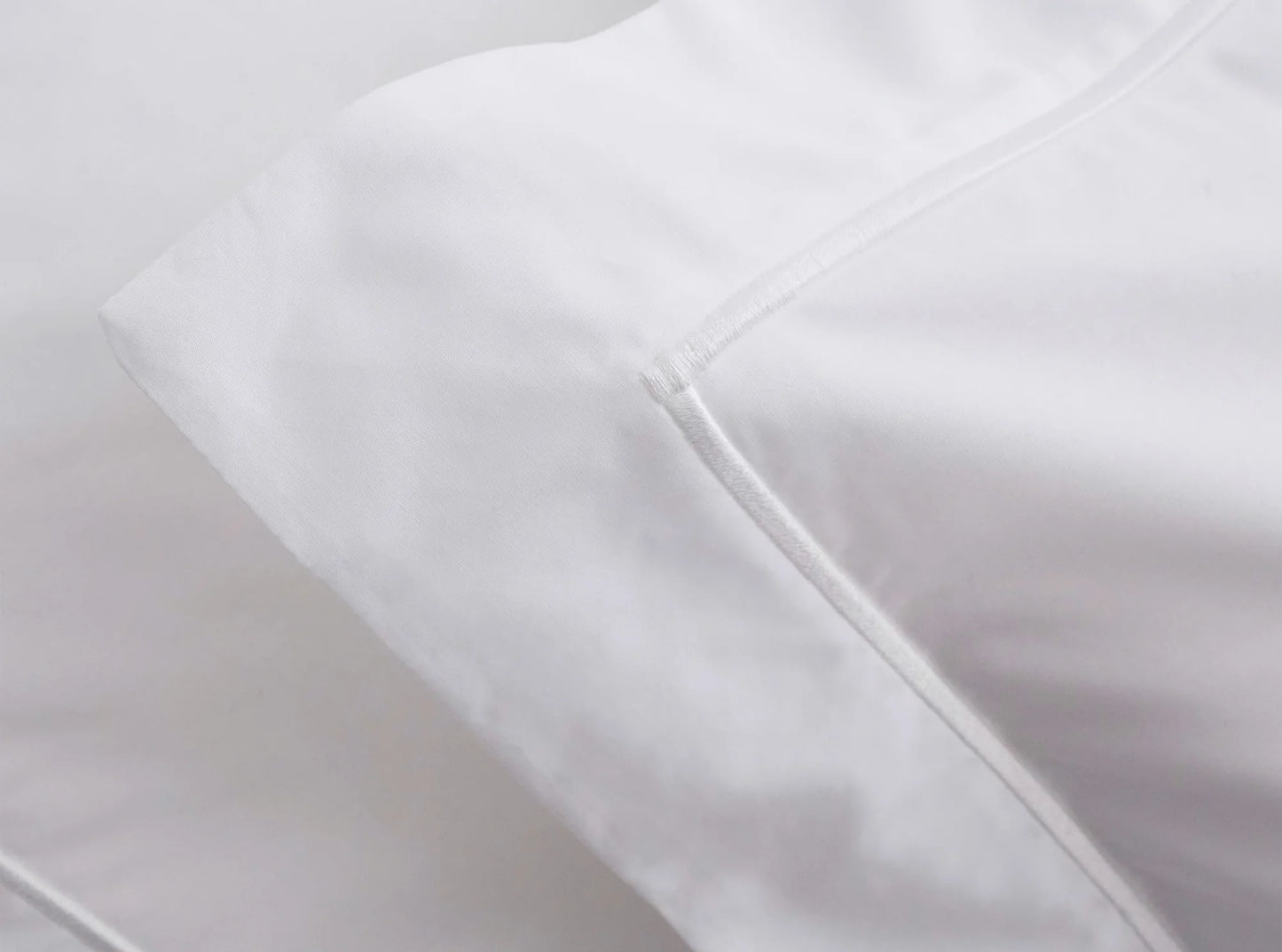 Close-up of embroidered detail on white organic cotton percale bedding bundle - handcrafted quality-white-white