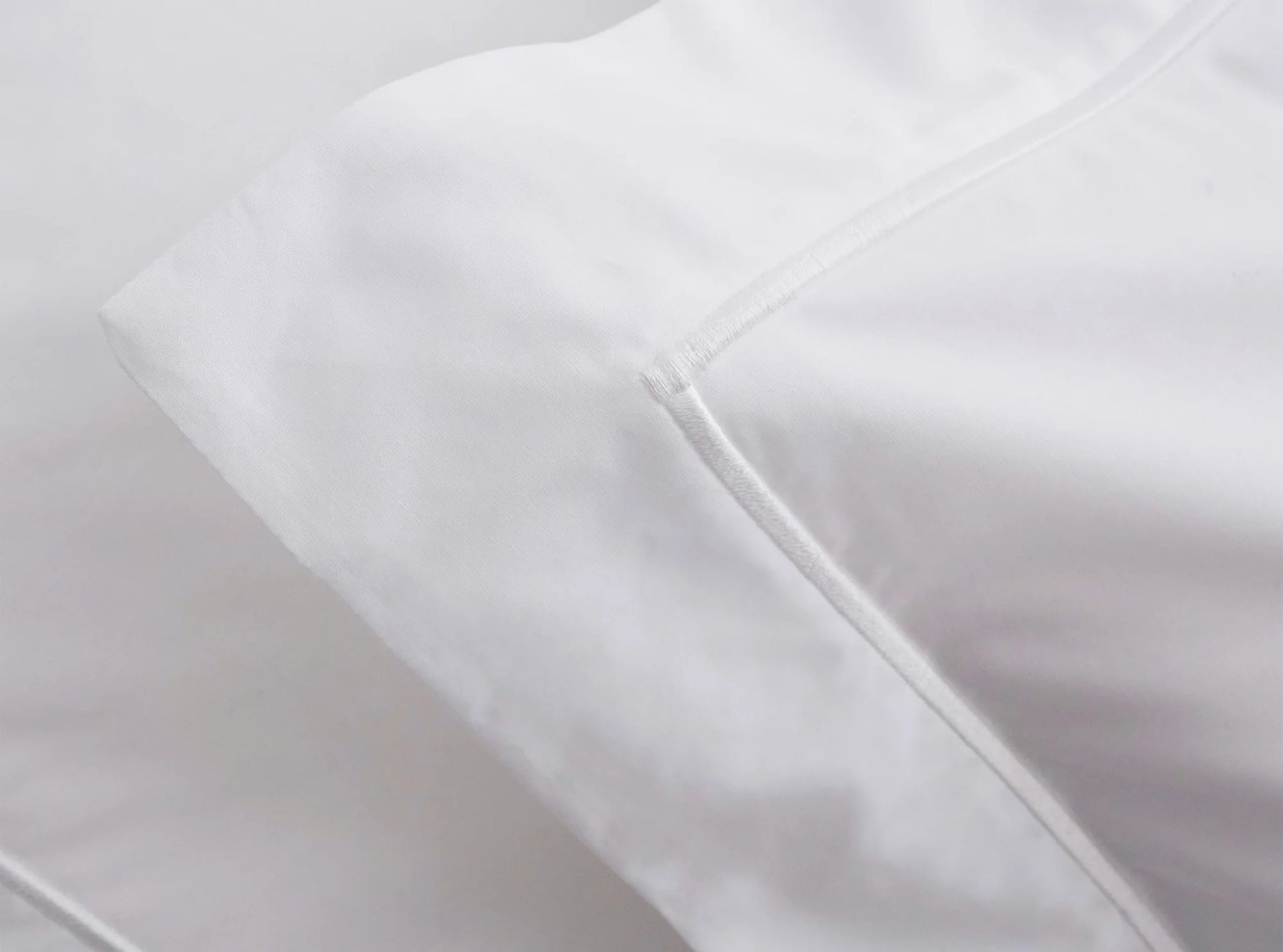 Close-up of embroidered detail on white organic cotton percale bedding bundle - handcrafted quality-white-white